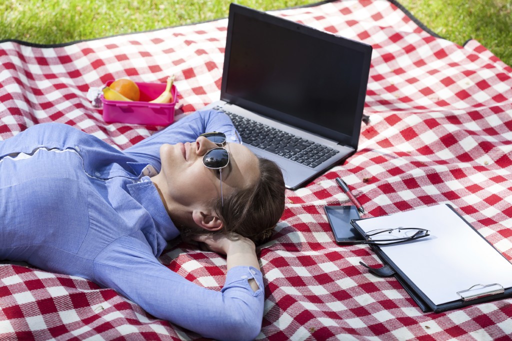 Working woman resting in a garden, horizontal